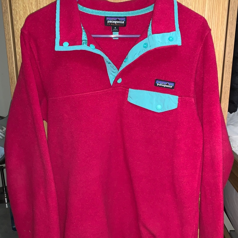 A pink and green button down fleece pullover